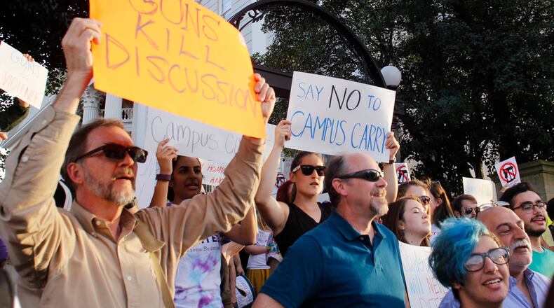 Protesters at a University of Georgia rally showed their dislike of last year’s campus carry legislation. While Gov. Nathan Deal vetoed the campus carry bill in 2016, another version of the bill is making its way through the Legislature and may reach his desk this year. TAYLOR CARPENTER / TAYLOR.CARPENTER@AJC.COM