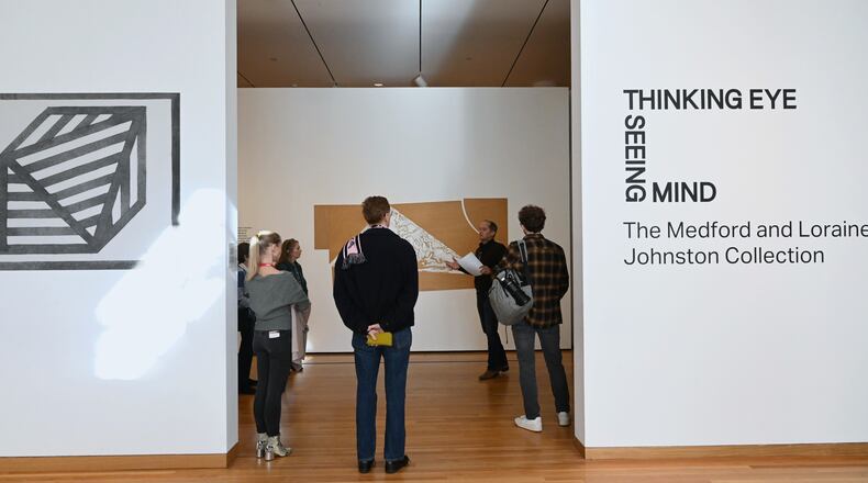 Michael Rooks, the High Museum of Art's senior curator of modern and contemporary art, leads a preview tour of “Thinking Eye, Seeing Mind: The Medford and Loraine Johnston Collection.” The exhibit continues at the High through May 25. (Hyosub Shin / AJC)