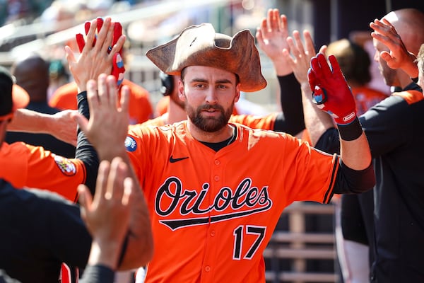 Baltimore Orioles' Colton Cowser high-fives teammates in the dugout after hitting a two-run home run in the fourth inning of a baseball game against the Atlanta Braves, Saturday, July 5, 2025, in Atlanta. (AP Photo/Colin Hubbard)