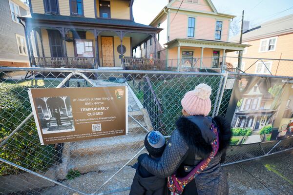 LaKeisha Edwards (right), 47, and her son, Garrett Edwards, 8, visit the Martin Luther King Jr. Birth Home on Sunday, Jan. 18, 2026. The historic site is temporarily closed. (Miguel Martinez/AJC)
