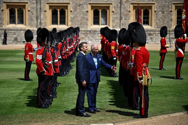Britain's King Charles III, center right, and French President Emmanuel Macron attend a welcome ceremony at Windsor Castle, in Windsor, England, Tuesday July 8, 2025, on the first day of a three-day state visit to Britain. (Dylan Martinez/Pool via AP)