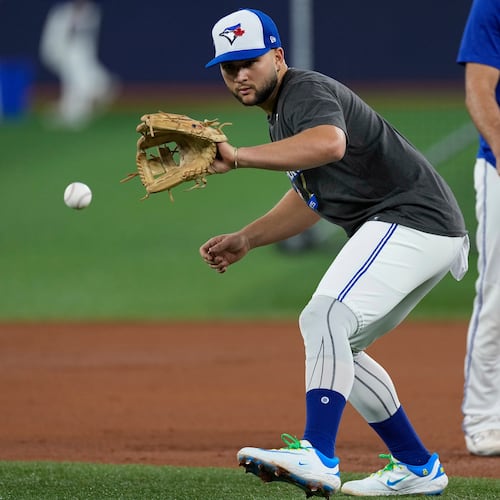 Toronto Blue Jays' Bo Bichette fields a ball during a World Series baseball media day, Thursday, Oct. 23, 2025, in Toronto. The Toronto Blue Jays face the Los Angeles Dodgers in Game 1 on Friday. (AP Photo/David J. Phillip)