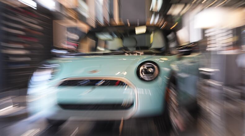 FILE - Made with a slow shutter speed and zoom lens, an unsold 2026 Cooper S hardtop is diplayed in a Mini dealership Friday, Oct. 24, 2025, in Highlands Ranch, Colo. (AP Photo/David Zalubowski, File)
