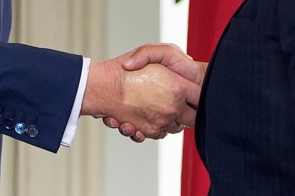 FILE - President Donald Trump, left, greets Bahrain's Crown Prince Salman bin Hamad Al Khalifa at the White House, July 16, 2025, in Washington. (AP Photo/Alex Brandon, File)