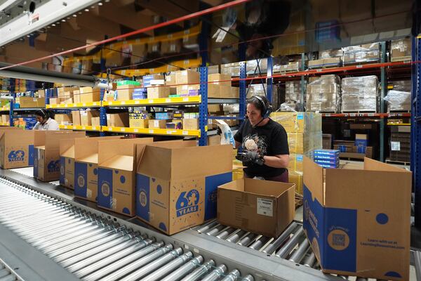 Employees of Learning Resources, an educational toy company, work at a warehouse in Vernon Hills, Ill., Friday, April 11, 2025. (AP Photo/Nam Y. Huh)