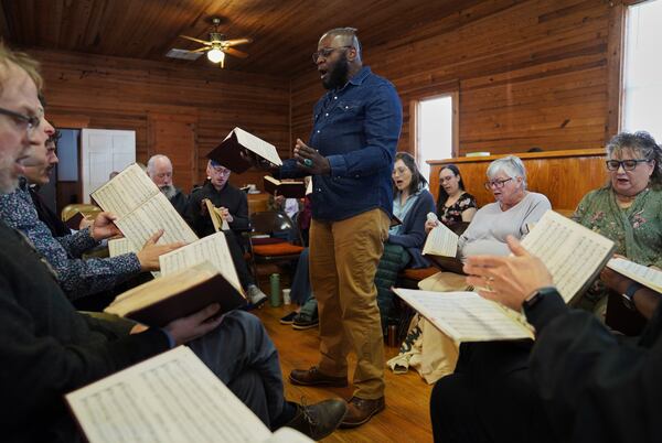 Bridge Hill Kennedy of Alabama stands in the hollow square and leads a song from "The Sacred Harp," at Holly Springs Primitive Baptist Church in Bremen, Ga., on Saturday, March 22, 2025. (AP Photo/Jessie Wardarski)
