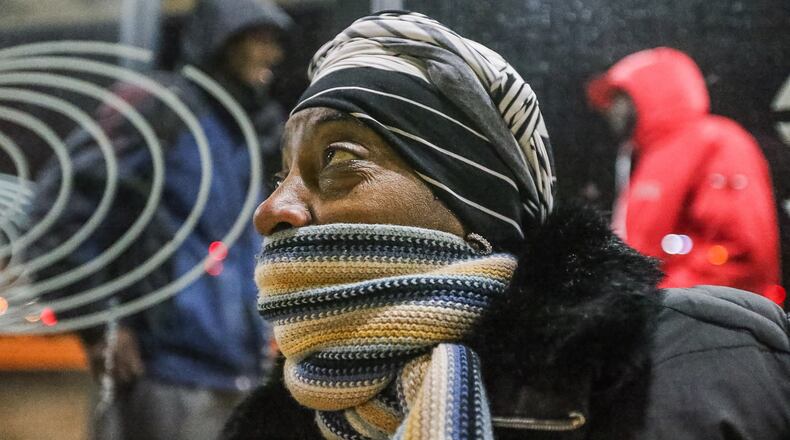 Viola Harshaw bundled up early Friday as she waited for a Cobb Community Transit bus at the Marietta Transfer Center. JOHN SPINK / JSPINK@AJC.COM