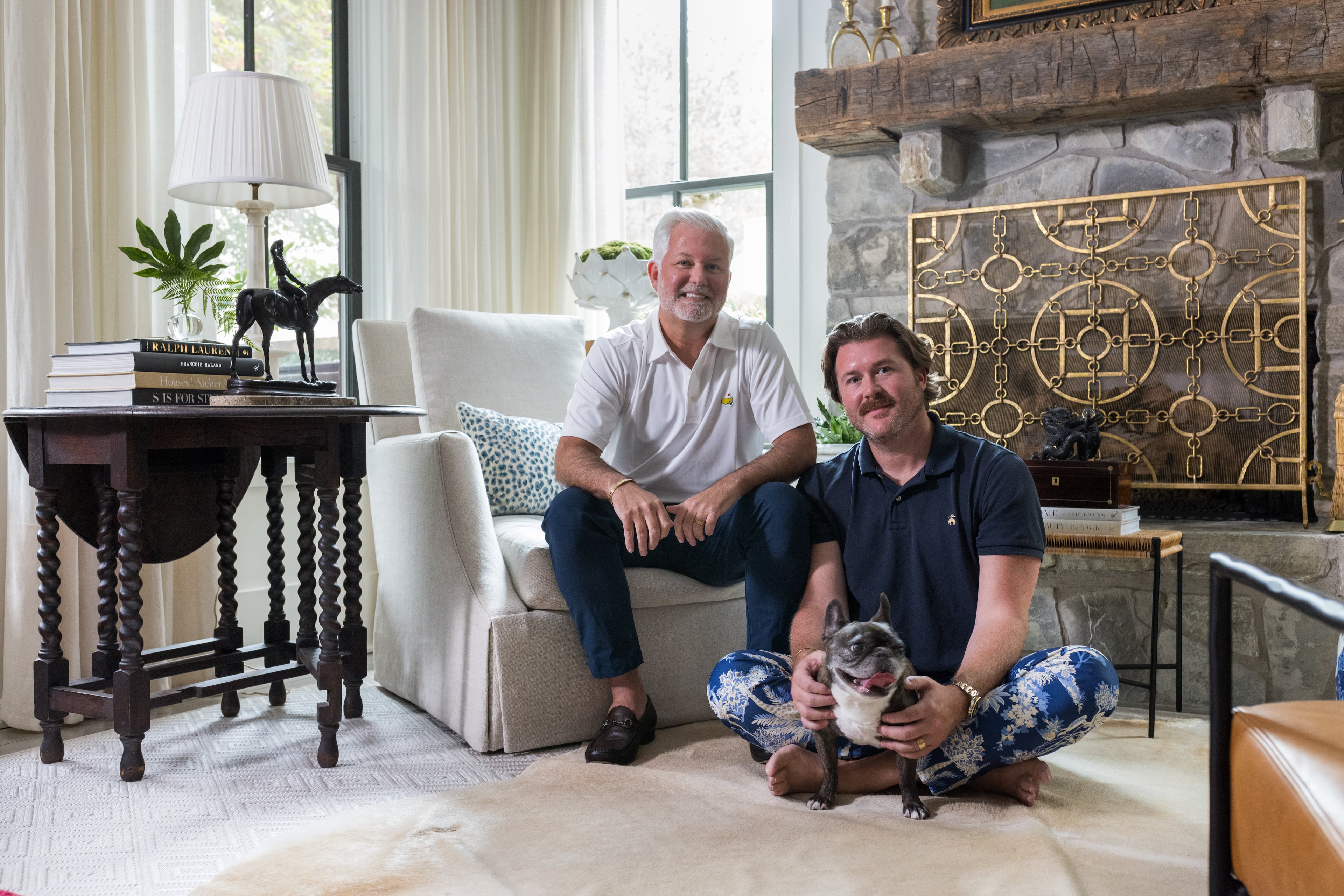Clinton Rice and Michael Mock — and French bulldog Rose — in the antiques-filled living room of their Serenbe home.