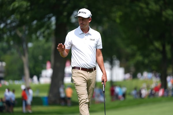 Andrew Putnam waves after his birdie putt on the eighth hole during the first round of the Rocket Classic golf tournament at the Detroit Golf Club, Thursday, June 26, 2025, in Detroit. (AP Photo/Paul Sancya)