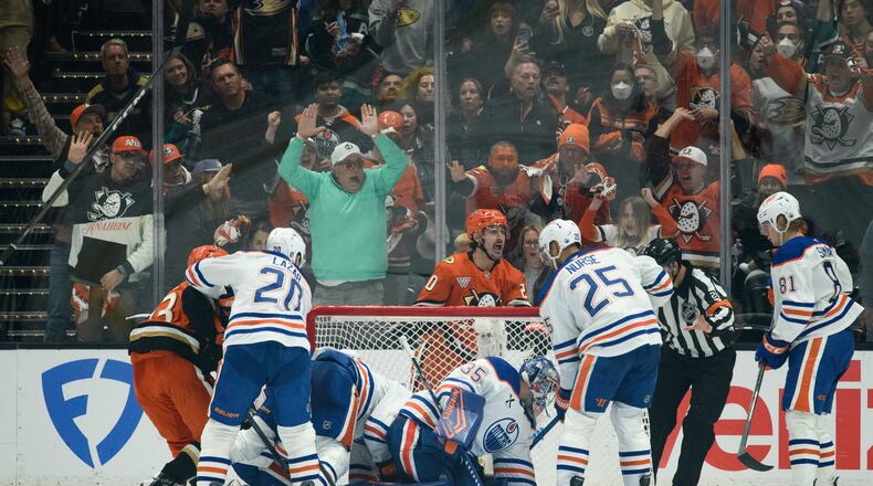 Anaheim Ducks left wing Chris Kreider, top center, reacts on the game-winning, overtime goal by center Ryan Poehling, not shown, in Game 4 in the first round of an NHL hockey Stanley Cup playoff series against the Edmonton Oilers, Sunday, April 26, 2026, in Anaheim, Calif. (AP Photo/Kyusung Gong)