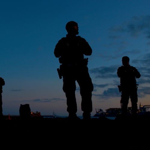 Spanish Civil Guard officers stand guard in the area where passengers from the MV Hondius cruise ship are expected to arrive at the port of Granadilla in Tenerife, Canary Islands, Spain, Saturday, May 9, 2026. (AP Photo/Manu Fernandez)