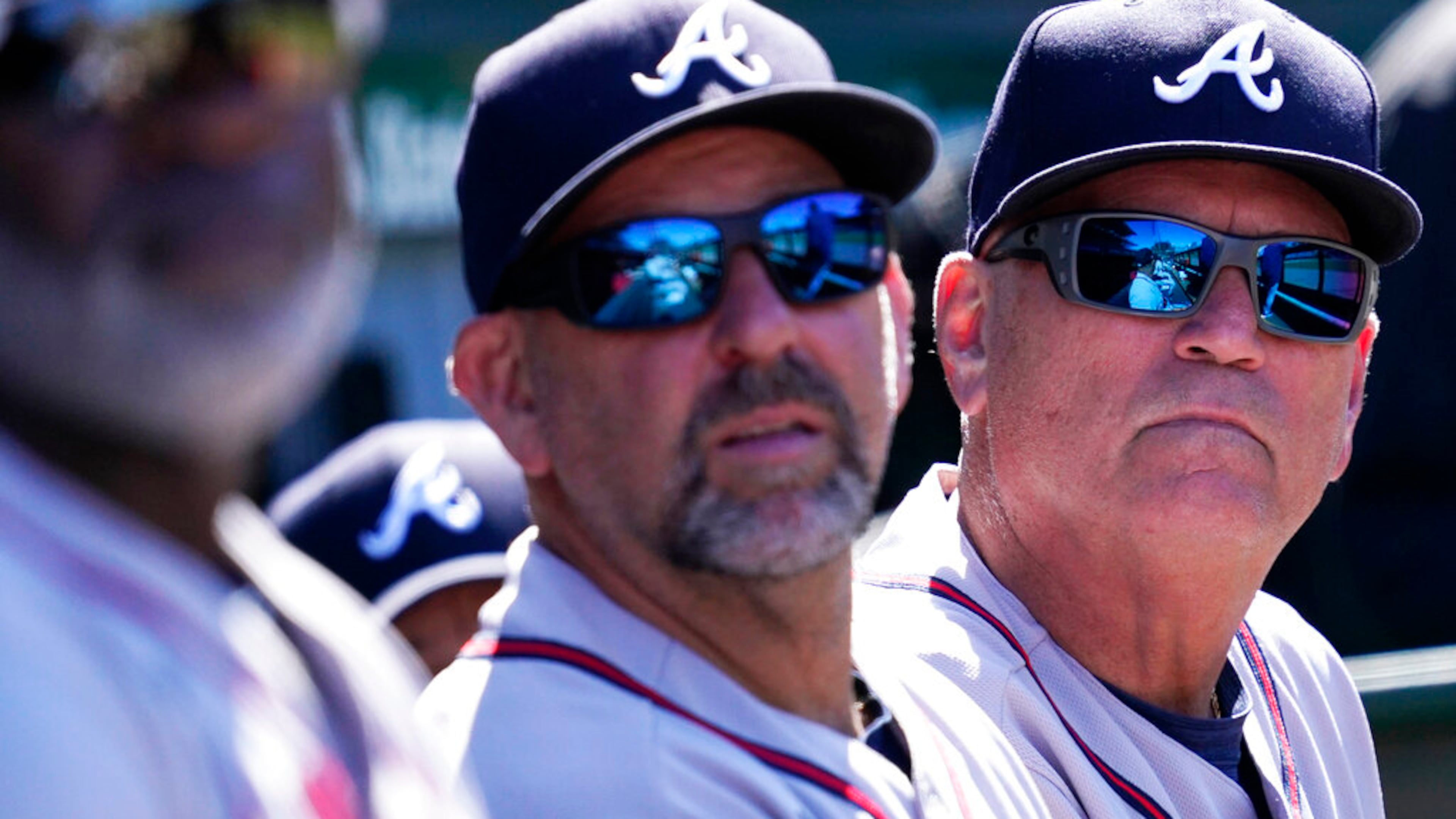 Atlanta Braves manager Brian Snitker, right, bench coach Walt Weiss, center, and first base coach Eric Young Sr., react as they watch after Chicago Cubs' Rafael Ortega hit a solo home run during the seventh inning of a baseball game in Chicago, Saturday, June 18, 2022. (AP Photo/Nam Y. Huh)