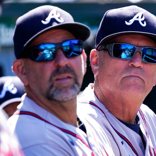 Atlanta Braves manager Brian Snitker, right, bench coach Walt Weiss, center, and first base coach Eric Young Sr., react as they watch after Chicago Cubs' Rafael Ortega hit a solo home run during the seventh inning of a baseball game in Chicago, Saturday, June 18, 2022. (AP Photo/Nam Y. Huh)