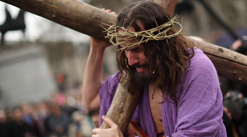 LONDON, ENGLAND - APRIL 03: Actor James Burke-Dunsmore playing Jesus drags the cross during the Wintershall's 'The Passion of Jesus' production on Good Friday in Trafalgar Square on April 3, 2015 in London, England. Good Friday is a Christian religious holiday before Easter Sunday, which commemorates the crucifixion of Jesus Christ on the cross. The Wintershall's theatrical production of 'The Passion of Jesus' includes a cast of 100 actors, horses, a donkey and authentic costumes of Roman soldiers in the 12th Legion of the Roman Army. (Photo by Dan Kitwood/Getty Images)