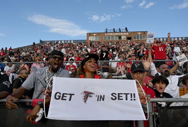 Fans cheer on the Falcons during Saturday's lightning-shortened scrimmage at Lanier High School. (Hyosub Shin/AJC)