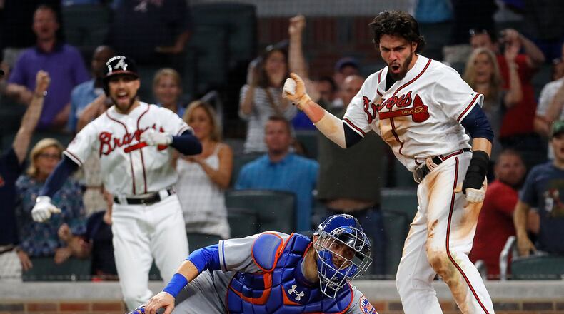 Dansby Swanson slides in with the winning run in the bottom of the ninth Friday as the Braves defeated the Mets 3-2 at SunTrust Park.