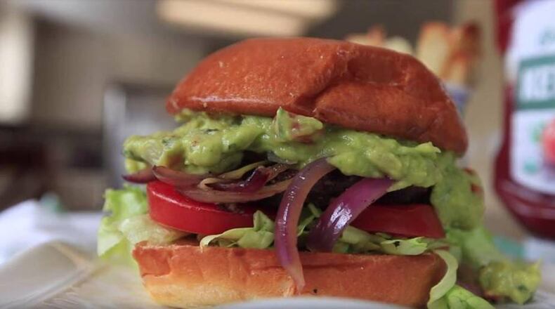 Homemade black bean burgers with local and fresh toppings. (Aleksandra Konstantinovic/Fresno Bee/TNS)
