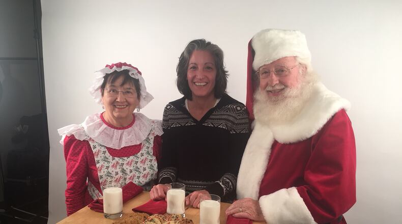 Mrs. Claus, AJC food editor Ligaya Figueras and Santa Claus do a cookie taste test.