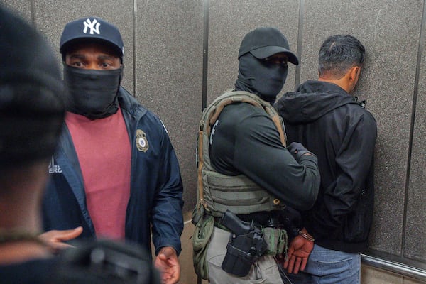 FILE - Immigration and Customs Enforcement agents escort a detained immigrant into an elevator after he exited an immigration courtroom, Tuesday, June 17, 2025, in New York. (AP Photo/Olga Fedorova, file)