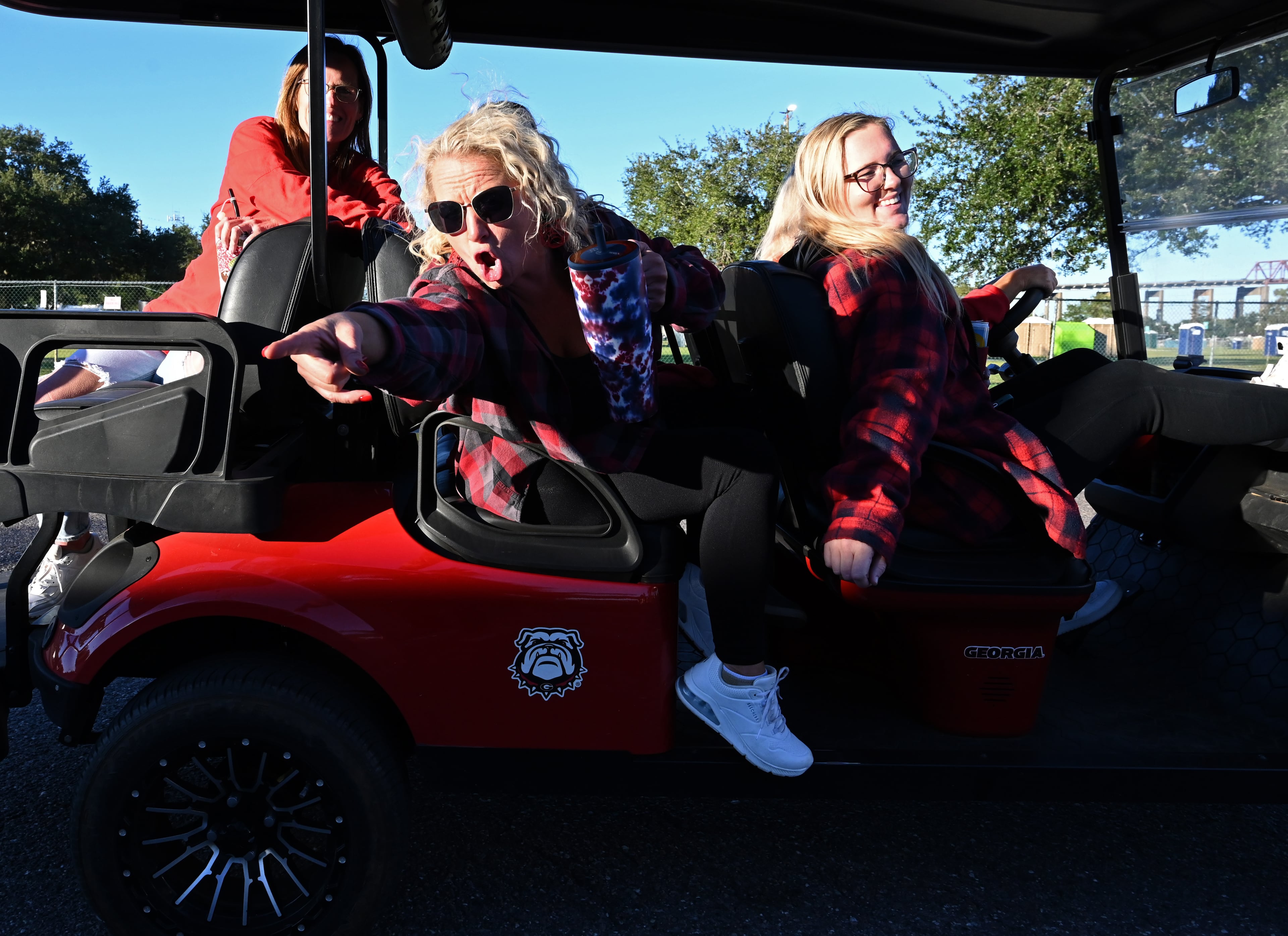 Georgia fans ride a decorated golf cart during tailgating ahead of the NCAA football game Saturday between Georgia and Florida in RV City outside EverBank Stadium, Friday, October 31, 2025, Jacksonville, Fla. (Hyosub Shin / AJC)