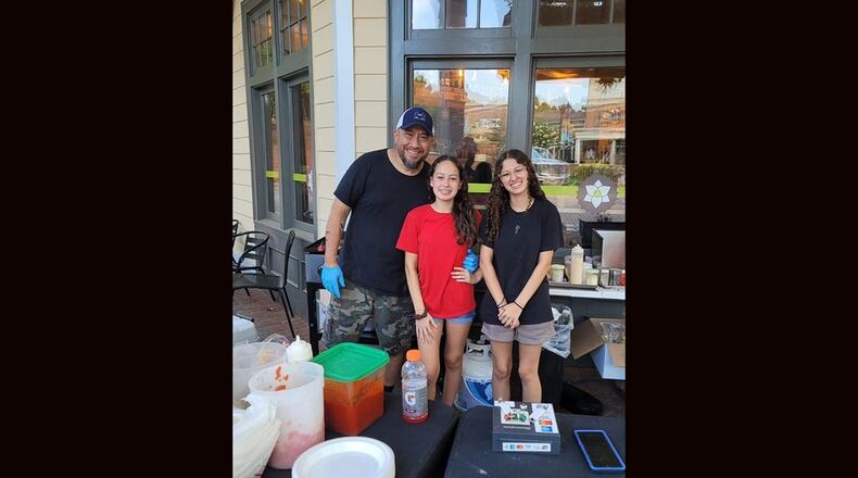 Jose Laos (from Left) and his daughters Caylee and Alexis are behind the Atlanta pop-up Jose's Birria Local. / Courtesy of Jose's Birria Local