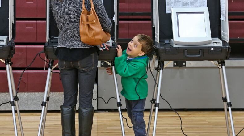 November 4, 2014 Atlanta: At Grady High School in Atlanta, Molly Goings cast her vote as her son, Harper-4 was in a playful mood Tuesday, Nov. 4, 2014. Atlanta voters hit the polls on Election Day with national implications in the U.S. Senate race and a deadlocked battle for governor. Voters reported much longer lines than usual Tuesday morning and sporadic problems across metro Atlanta. Georgia requires election winners to receive a majority of the vote - you’ll often hear politicos refer to this margin as “50 percent plus one (vote).” Several key races this fall have more than two candidates, making runoff elections possible. Georgia keeps separate election schedules for state and federal races. It is therefore possible to have runoffs on separate days: Dec. 2 for state and local races including governor, and Jan. 6 for federal races including the U.S. Senate. JOHN SPINK/JSPINK@AJC.COM November 4, 2014 At Grady High School in Atlanta, Molly Goings cast her vote as her son, Harper, 4, was in a playful mood AJC/John Spink