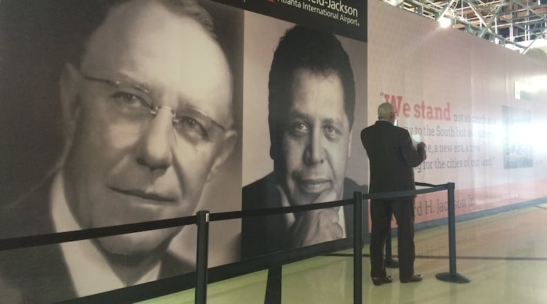 A limo driver awaits a customer in front of the new posters promoting former Atlanta mayors Hartsfield and Jackson.