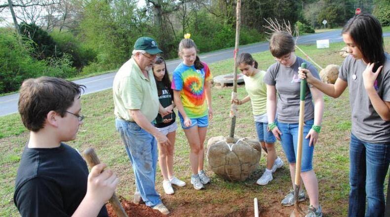 Milton City Arborist Mark Law supervises students during a previous Arbor Day tree planting. The city has honored Law by naming its new arboretum after him. CITY OF MILTON