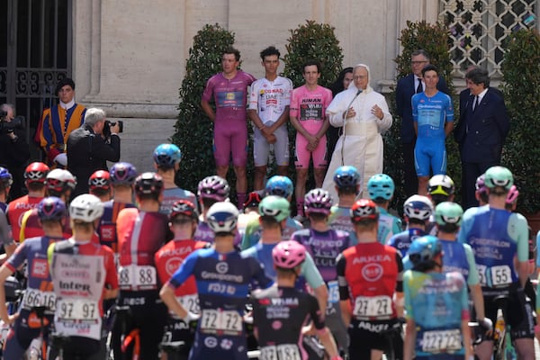 Flanked by race leaders, from left, Denmark's Mads Pedersen, Mexico's Isaac Del Toro, Britain's Simon Yates and Italy's Lorenzo Fortunato, Pope Leo XIV blesses the pack before the start of the final stage of the Giro d'Italia inside the Vatican, Sunday, June 1, 2025. (AP Photo/Andrew Medichini)