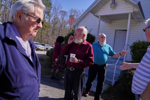 Winfred Kerr, left, Jesse Roberts, and Oscar McGuire stand outside during a break at a Sacred Harp singing event at Holly Springs Primitive Baptist Church in Bremen, Ga., on Saturday, March 22, 2025. (AP Photo/Jessie Wardarski)
