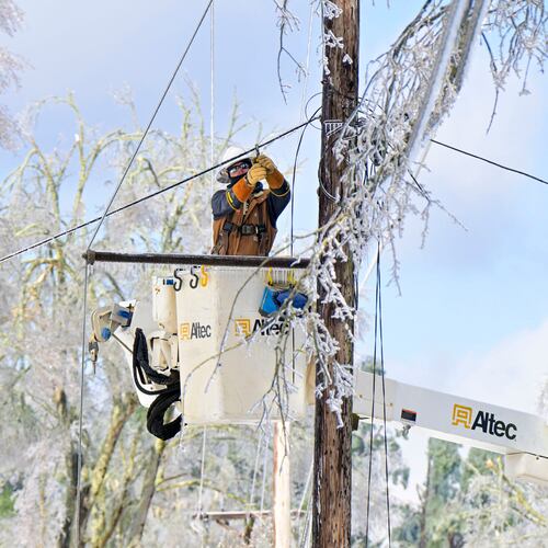 A lineman works to restore power in Oxford, Miss. on Monday, Jan. 26, 2026, following a weekend ice storm. (AP Photo/Bruce Newman)