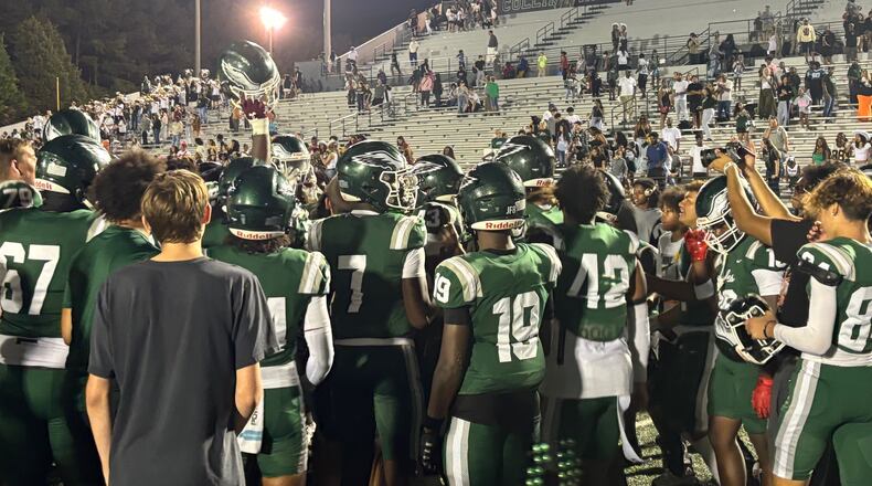 The Collins Hill football team celebrates after its 21-14 win over Woodward Academy, Aug. 24, 2024.