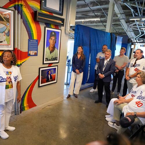 Joyce Henderson, left, sister of Glenn Burke, speaks during a ceremony prior to a baseball game to unveil a tribute to LGBTQ+ trailblazers and former Los Angeles Dodgers players Billy Bean and Burke, who were among the first professional athletes to identify as gay, Friday, June 5, 2026, in Los Angeles. (AP Photo/Mark J. Terrill)