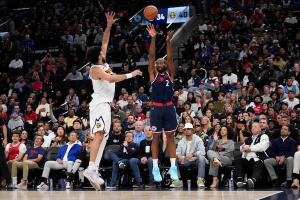 Los Angeles Clippers forward Kawhi Leonard, right, shoots as Denver Nuggets guard Jamal Murray, left, defends during the first half in Game 4 of an NBA basketball first-round playoff series Saturday, April 26, 2025, in Inglewood, Calif. (AP Photo/Mark J. Terrill)