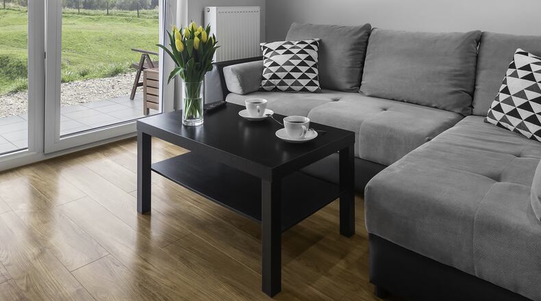 If there is one thing every living room needs, it’s a cozy sofa that looks designer but doesn’t make your credit card go into hiding. (Dreamstime)