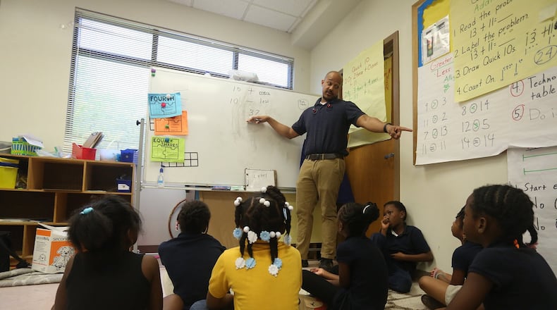 First grade teacher Malcolm Davis teaches his students basic math skills.