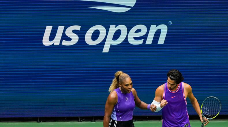Serena Williams, of the United States, and Carlos Alcaraz, of Spain, react during a mixed doubles match at the U.S. Open tennis championships, Tuesday, Aug. 25, 2026, in New York. (AP Photo/Yuki Iwamura)