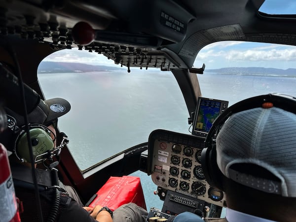 Crew fly a helicopter flying over the Bali Strait during a search operation for the victims of a late Wednesday ferry sinking near the resort island of Bali, Indonesia, Friday, July 4, 2025. (AP Photo/Firdia Lisnawati)
