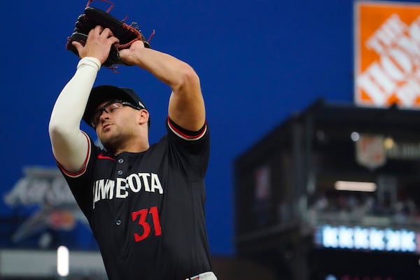 Minnesota Twins first base Jonah Bride (31) catches a pop fly ball against the Atlanta Braves during the third inning in a baseball game at Truist Park, Saturday, April 19, 2025, in Atlanta. (AP Photo/ John David Mercer)