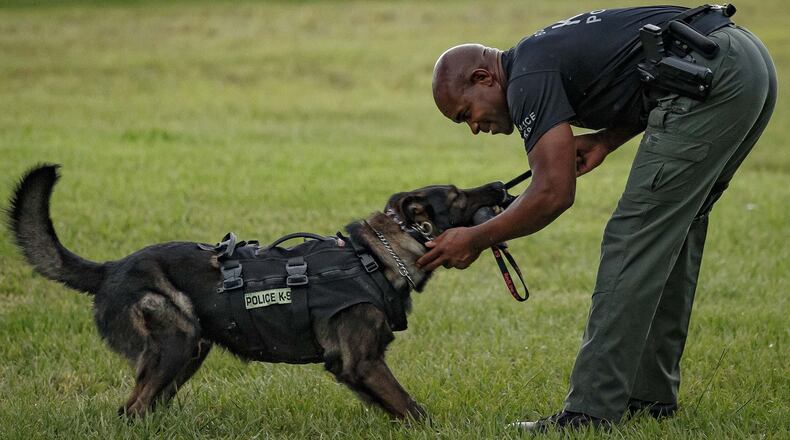 A K-9 and his officer work out in Boynton Beach, Florida, on June 30, 2016.
