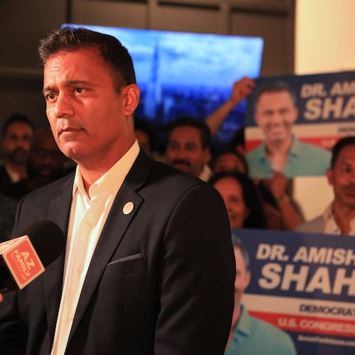 Amish Shah, who is seeking the Democratic nomination for Arizona's 1st Congressional District, speaks to supporters at a friend's home on Tuesday, July 21, 2026, in Phoenix. (AP Photo/Wufei Yu)