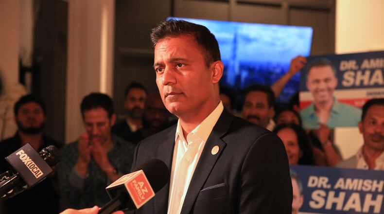 Amish Shah, who is seeking the Democratic nomination for Arizona's 1st Congressional District, speaks to supporters at a friend's home on Tuesday, July 21, 2026, in Phoenix. (AP Photo/Wufei Yu)