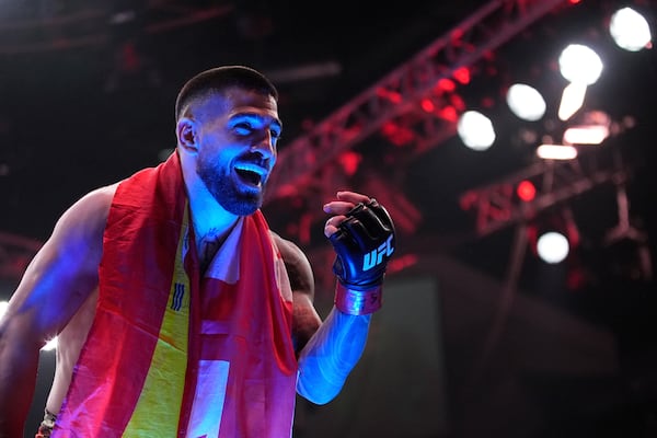 Ilia Topuria celebrates after defeating Charles Oliveira in a lightweight title fight at UFC 317, Saturday, June 28, 2025, in Las Vegas. (AP Photo/John Locher)
