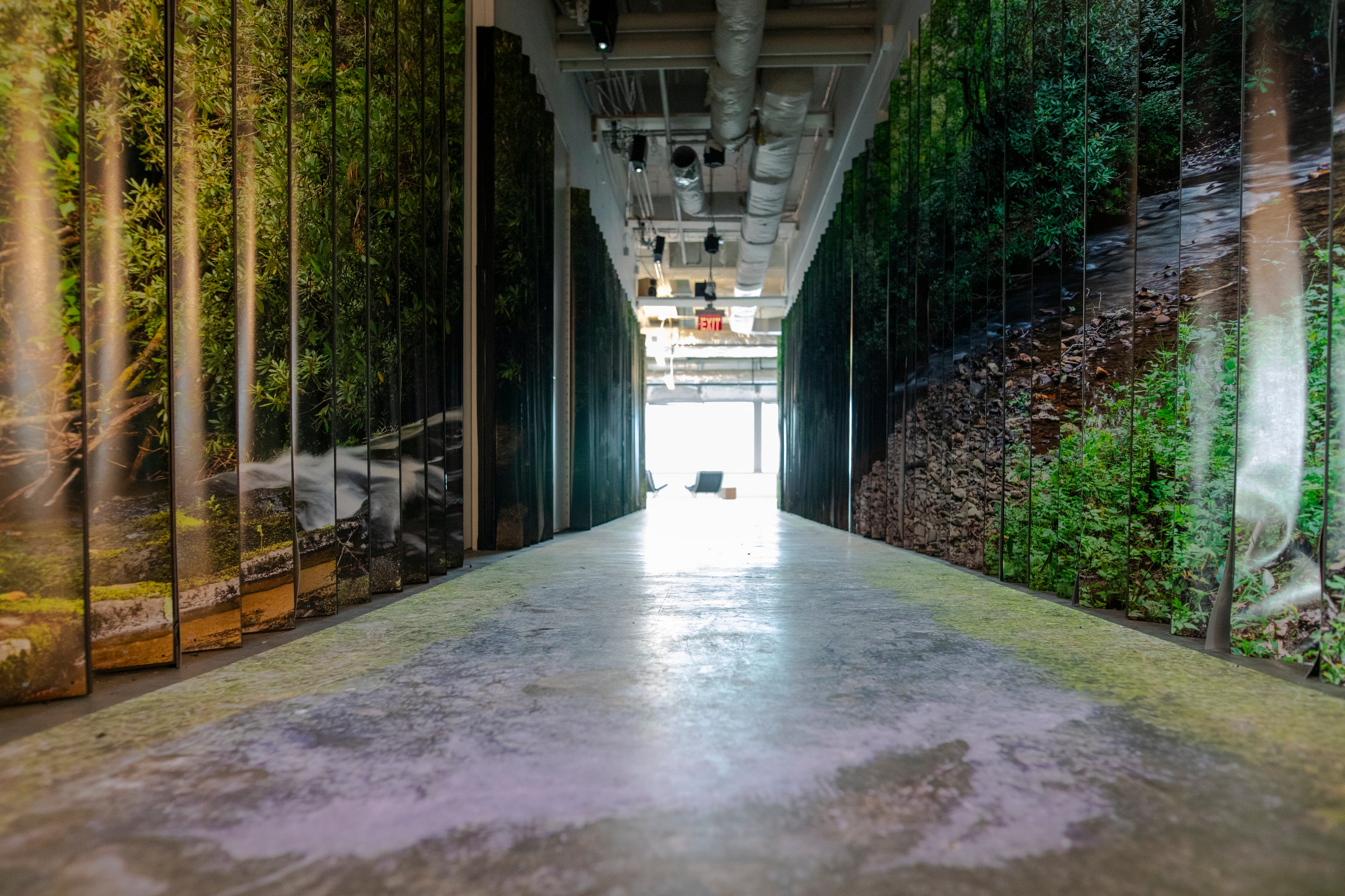 "all streams flow into the sea, yet the sea is never full" (2025) by Joel Silverman invites visitors to walk atop a projection of a stream. (Isadora Pennington/ArtsATL)