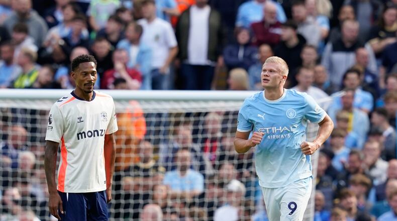 Manchester City's Erling Haaland, right, celebrates after scoring his side's opening goal during the English Premier League soccer match between Manchester City and Coventry City in Manchester, England, Saturday, Sept. 5, 2026. (AP Photo/Dave Thompson)