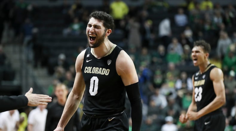 Colorado guard Luke O'Brien (0) and forward Tristan da Silva (23) celebrate their team's 79-75 win over Oregon in an NCAA college basketball game Thursday, March 7, 2024, in Eugene, Ore. (AP Photo/Amanda Loman)