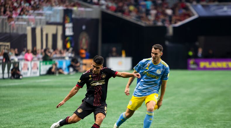 Thiago Almada,  midfielder for Atlanta United, passes the ball with pressure from Philadelphia Union midfielder Dániel Gazdag during the Philadelphia Union vs. Atlanta United soccer game on Saturday, September 17, 2022, at Mercedes Benz Stadium in Atlanta.  Atlanta United tied Philadelphia Union 0-0. CHRISTINA MATACOTTA FOR THE ATLANTA JOURNAL-CONSTITUTION.
