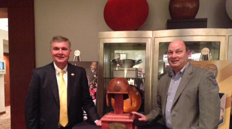 Georgia Tech coach Paul Johnson and Peach Bowl CEO Gary Stokan pose with the trophy for the Chick-fil-A Kickoff game at the ACC Kickoff in Charlotte, N.C., Friday. The game is to be played Sept. 4 between Tech and Tennessee at the Mercedes-Benz Stadium. (AJC photo by Ken Sugiura)