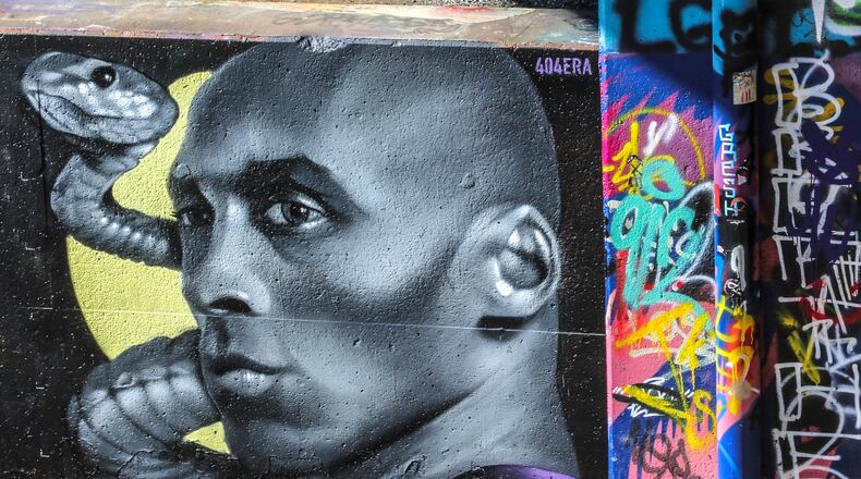 January 24, 2020 Atlanta: A runner passes the mural area artist, Era finished with touch ups of his Kobe Bryant and the Mamba on Tuesday. The area artist began the mural Monday at Noon and wanted to give the mural a "sculptural quality." Two Atlanta area artists, Era and Nels (not pictured) finished doing touch ups on their two separate and individually painted murals honoring the late NBA superstar Kobe Bryant on Tuesday, Jan. 28, 2020.  The murals were begun on Monday along the Beltline not far from the Baby Yodas murals near the Historic Fourth Ward Skatepark. âThe City of Atlanta joins the world in mourning the loss of Kobe Bryant, his daughter Gianna, and all the other passengers on board. Our thoughts and prayers are with their family and friends,â officials said. JOHN SPINK/JSPINK@AJC.COM