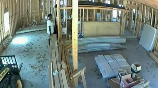 Jurors in the state trial were shown surveillance video of Ahmaud Arbery walking through the home under construction moments before he was killed.